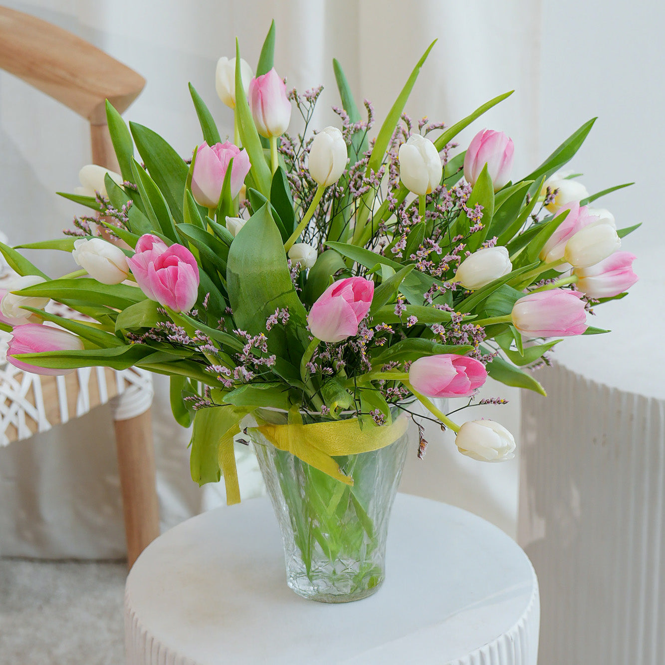 Pink and white orchid in white vase