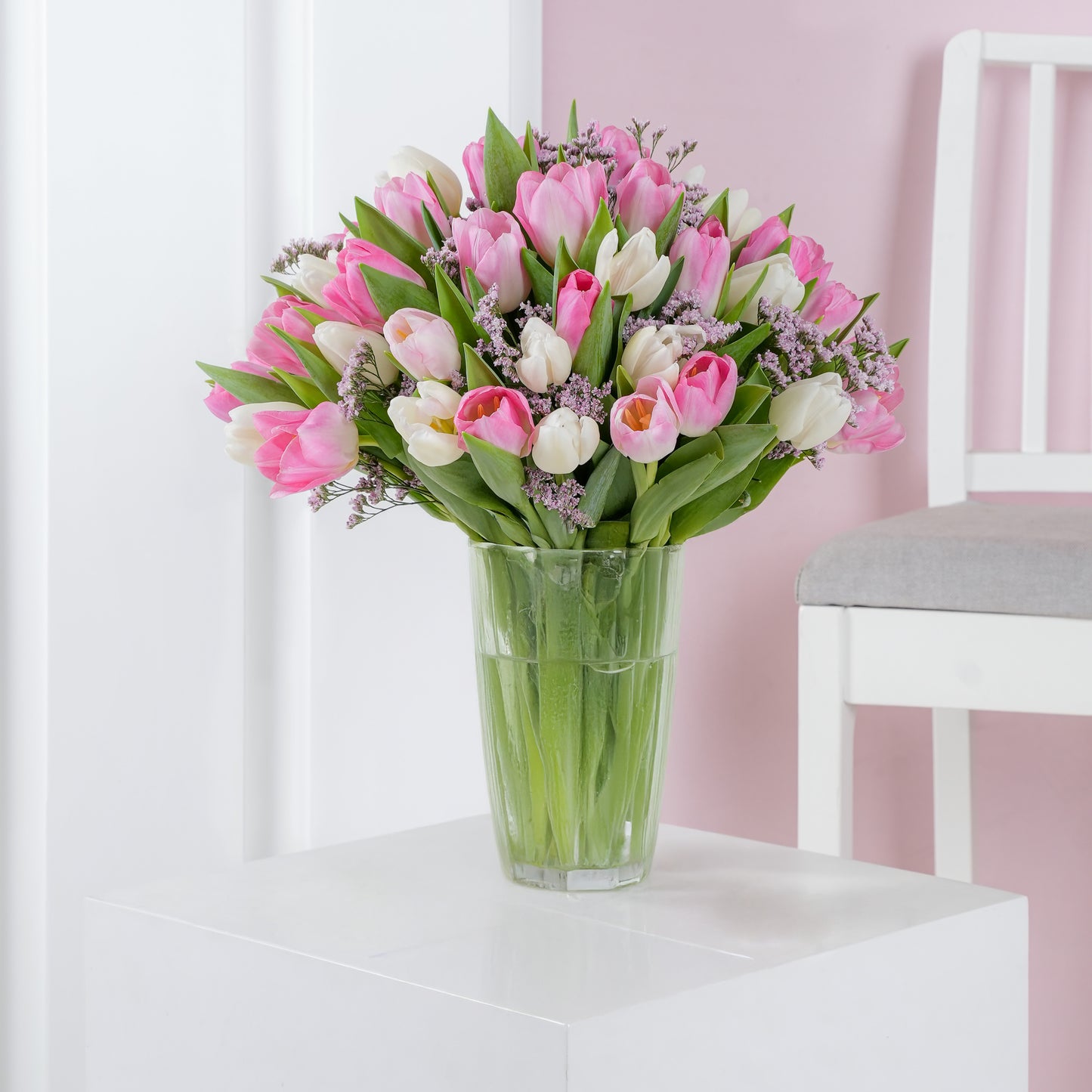 Pink and white orchid in white vase